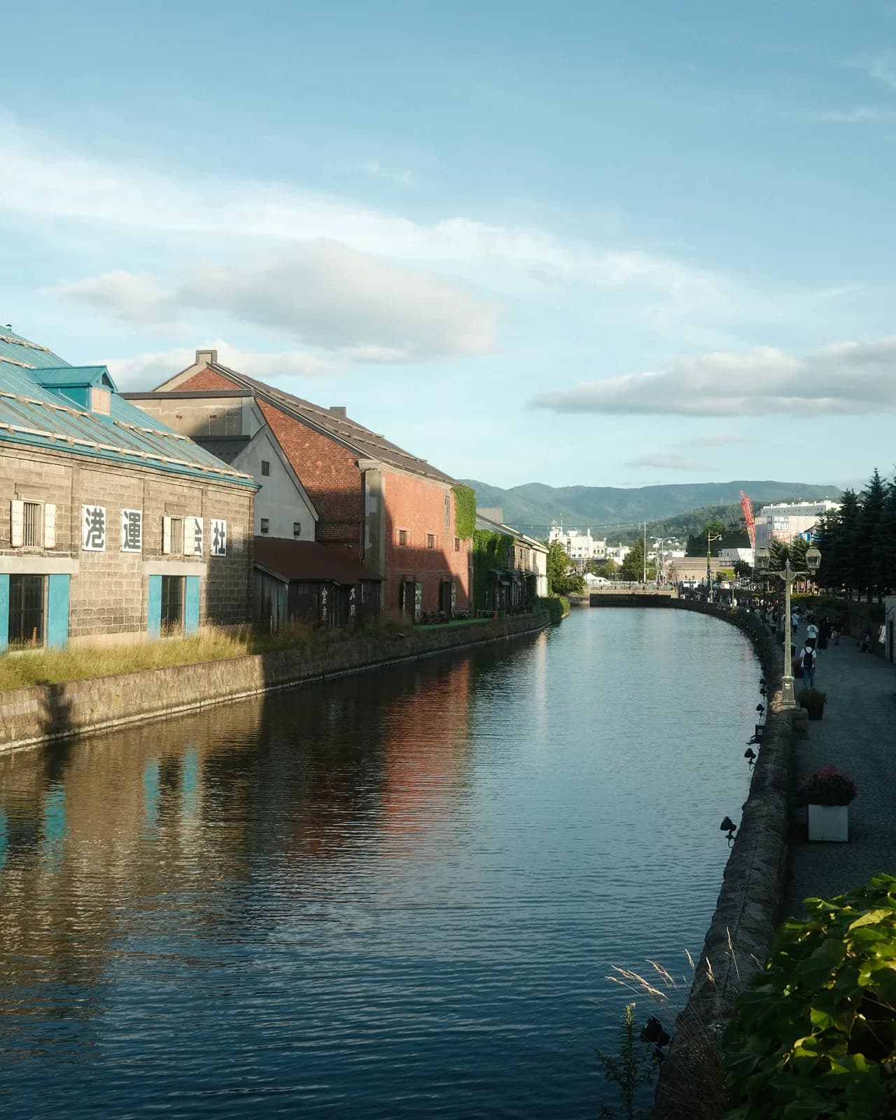 Historic stone warehouses reflected in the calm water of Otaru Canal, Hokkaido